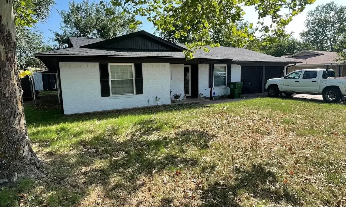 Professional roofing crew working on a residential roof in Sunset